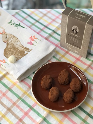 Photo of chocolate truffles, with earl grey tea in the background.