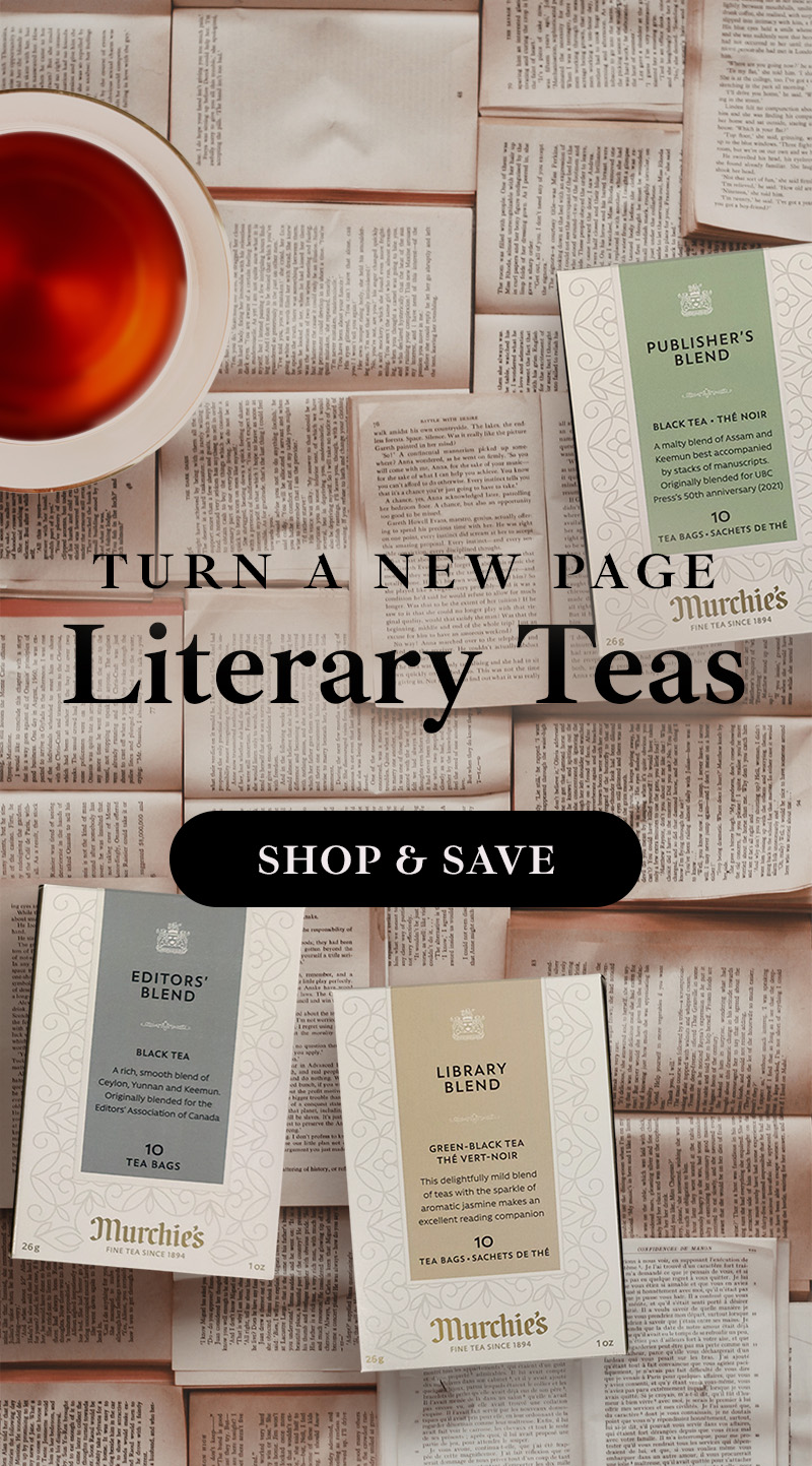 Variety of reading materials underneath a teacup, other books, and Murchie's fine tea.